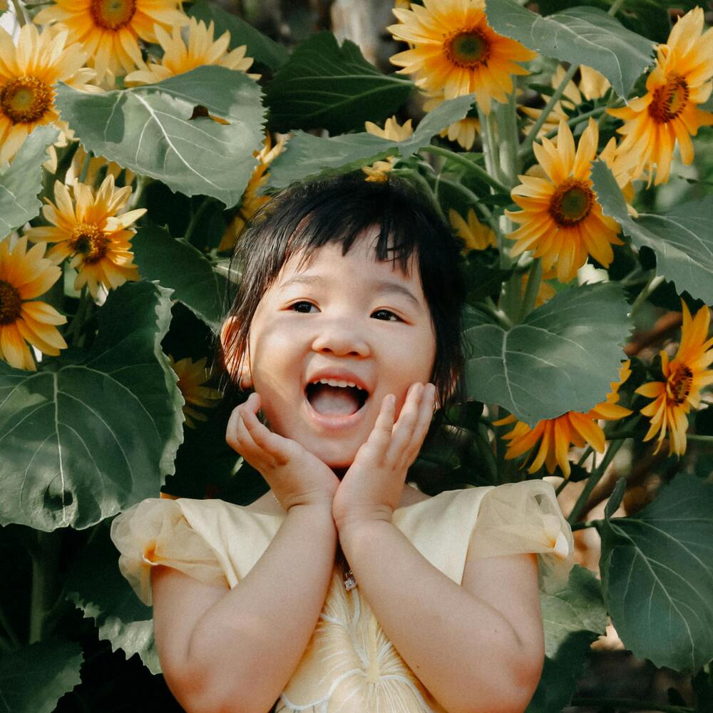 Beautiful baby with garden flowers