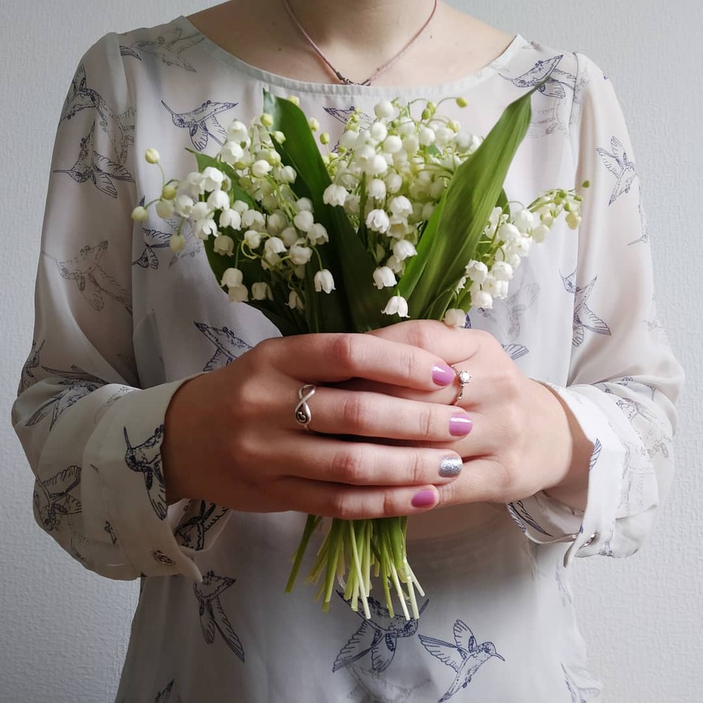 Holding bunch of lily of the flower