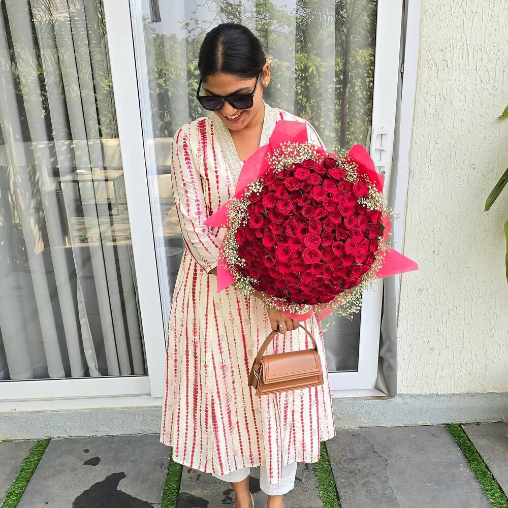 Indian lady holding Red Rose Bouquet