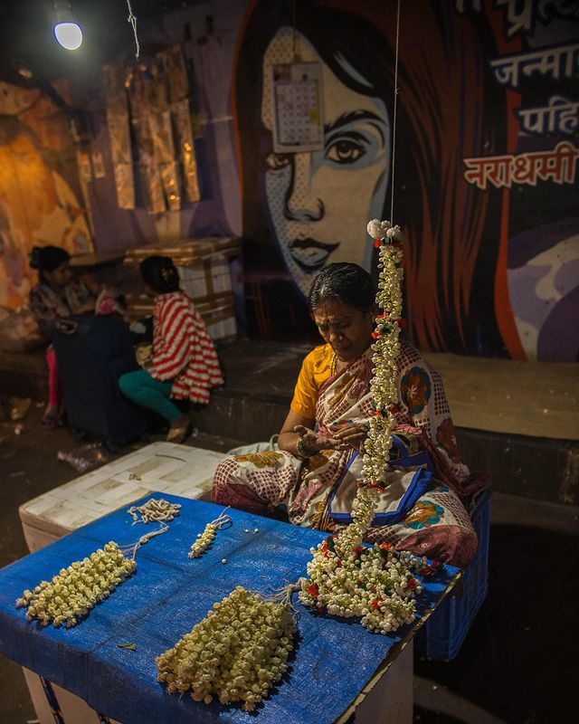 A lady vendor selling jasmine garlands locally known as 'gajra' (used for hair styling)