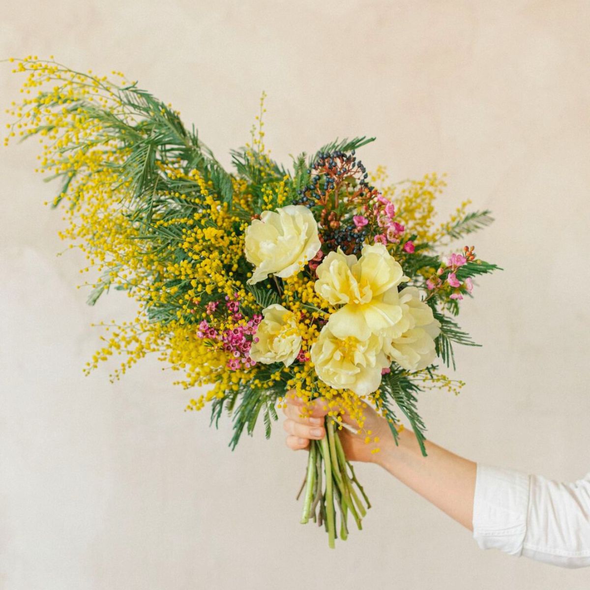 Yellow toned arrangement with mimosa flowers