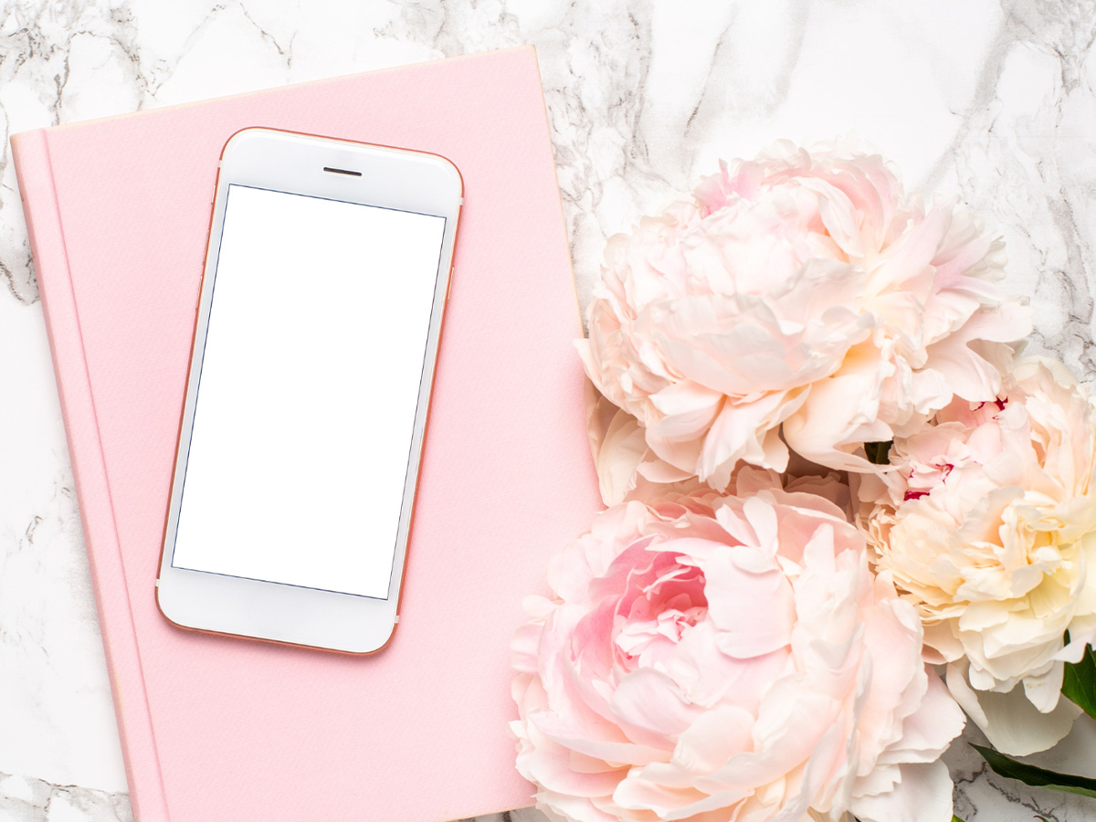 Pink peonies with a smartphone