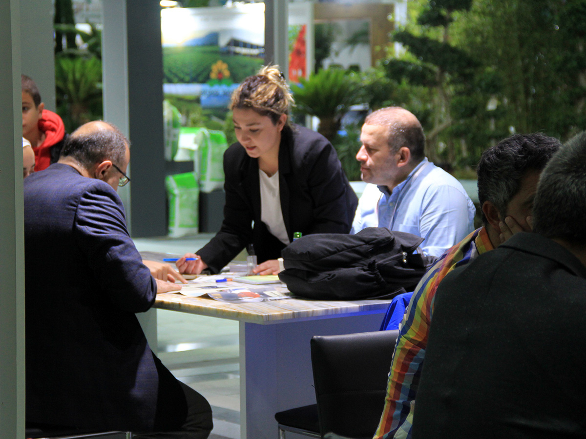 Landscape Istanbul Fair 2023 lady in booth explaining