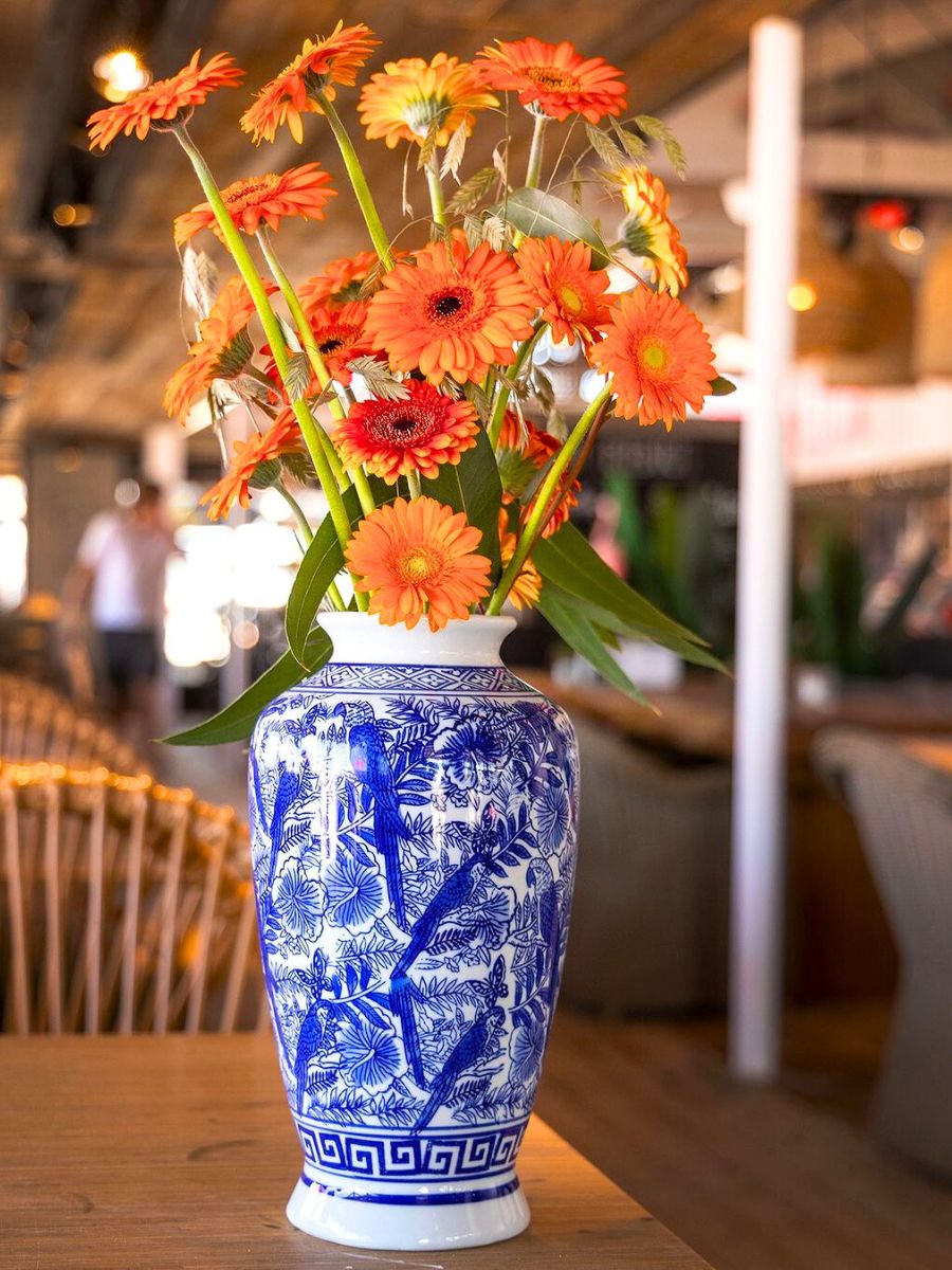 Orange gerberas in a blue chinese vase