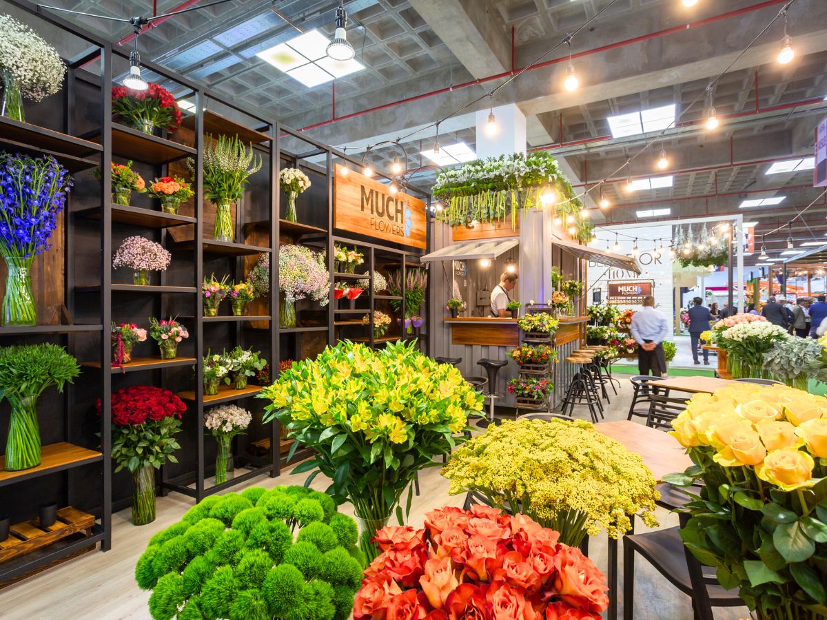 Exhibitor stands decorated with colorful flowers