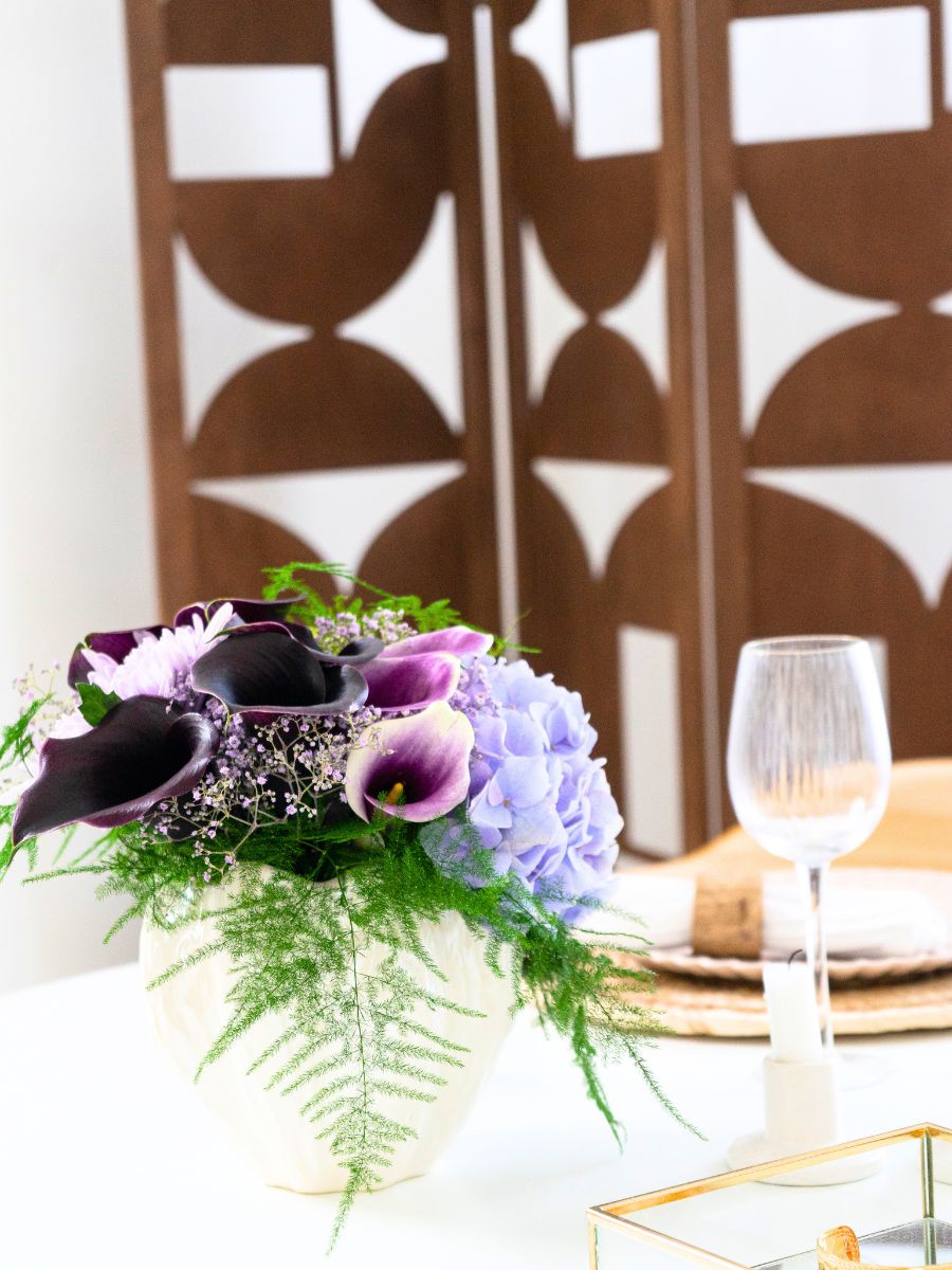 Lilac and burgundy callas in a patterned background