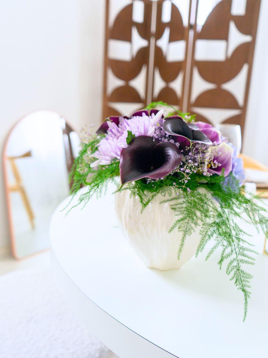 Burgundy callas in a neutral vase