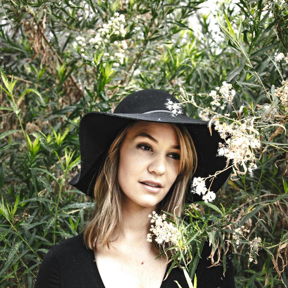 Lady with white outdoor flowering plant