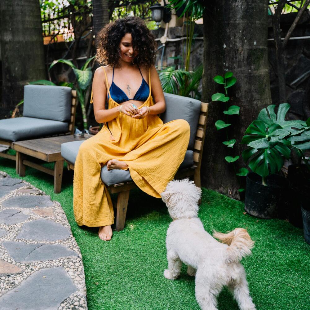 lady playing with dog in garden