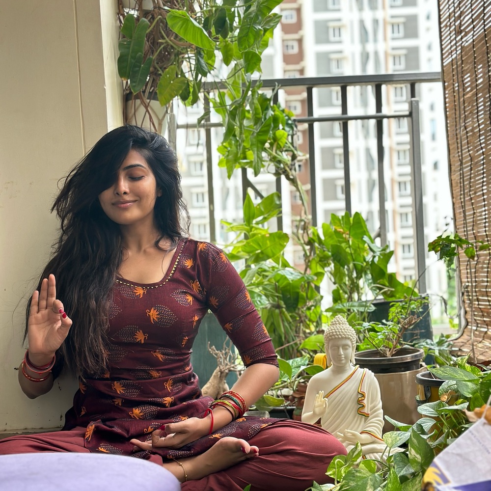 lady doing yoga in indoor garden