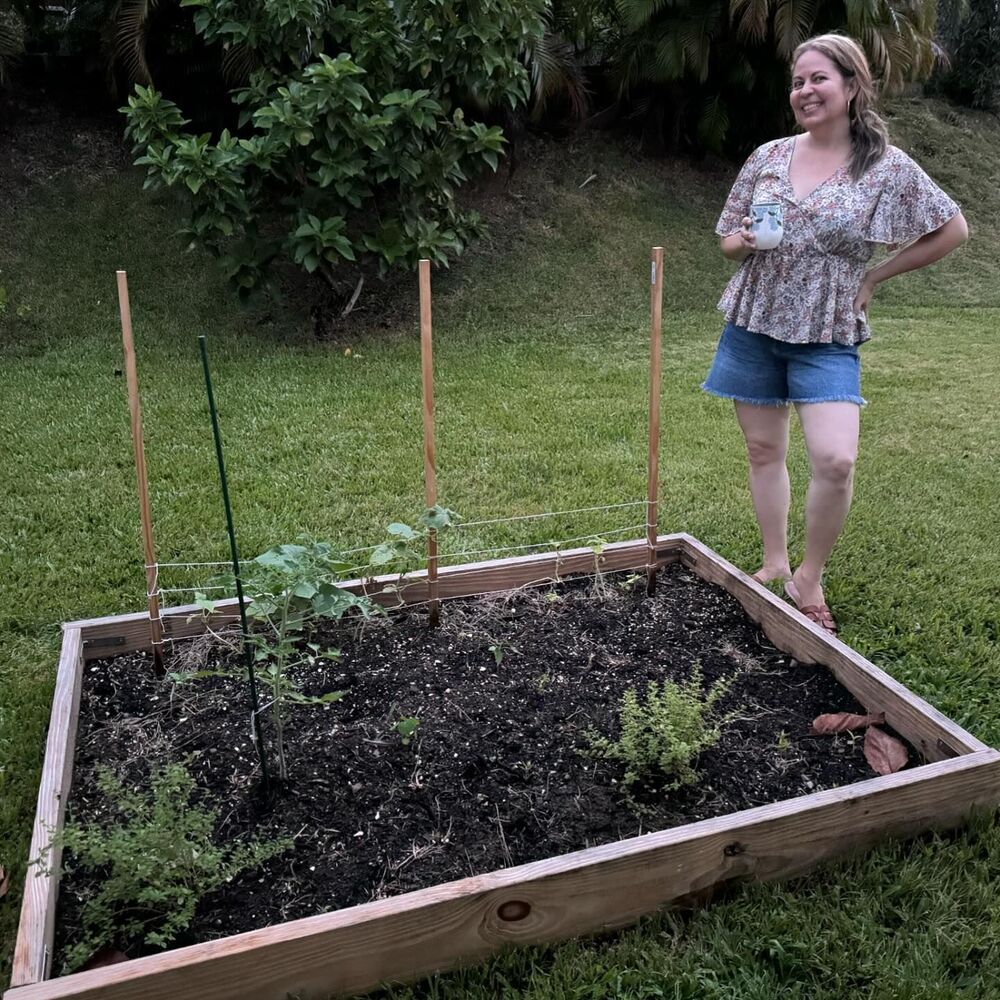 lady with new plant in outdoor garden