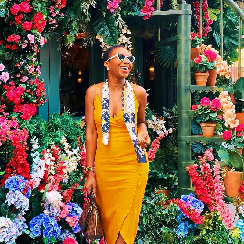 Visitor at the Ivy Chelsea restaurant filled with flowers and plants