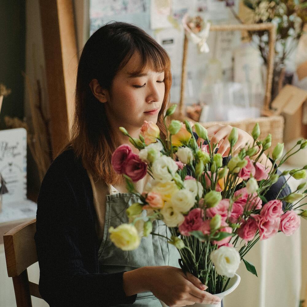 Lady holding bunch of flowers