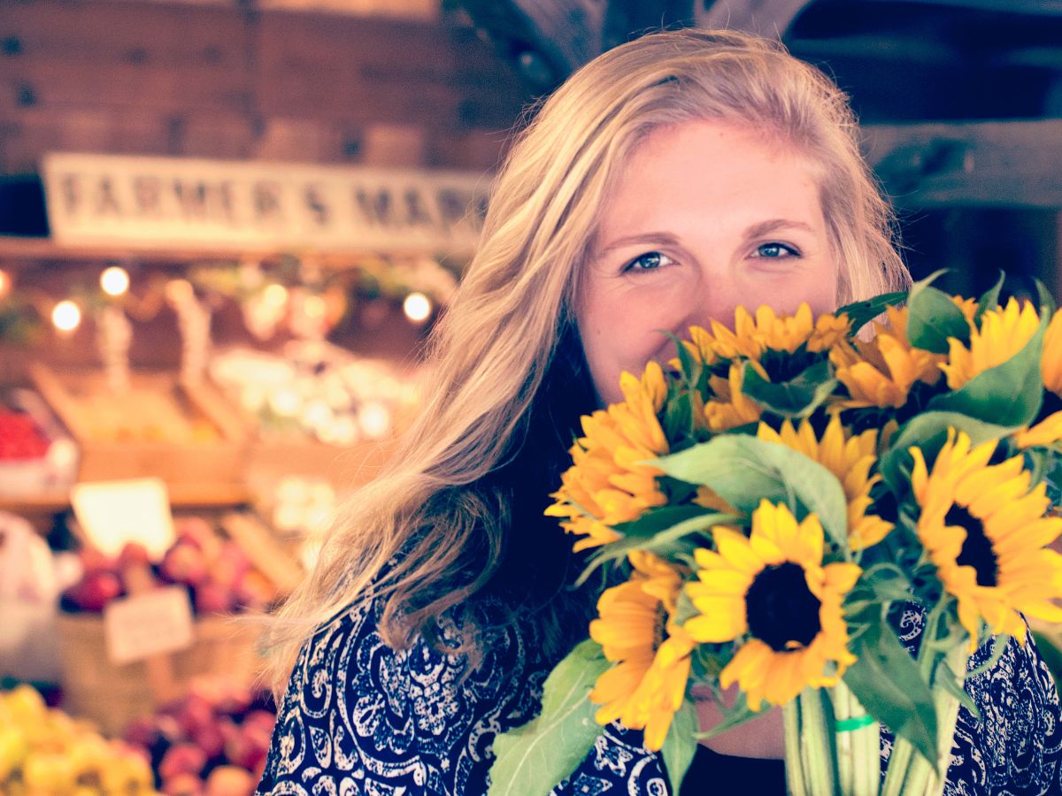 Happy girl with sunflower bouquet