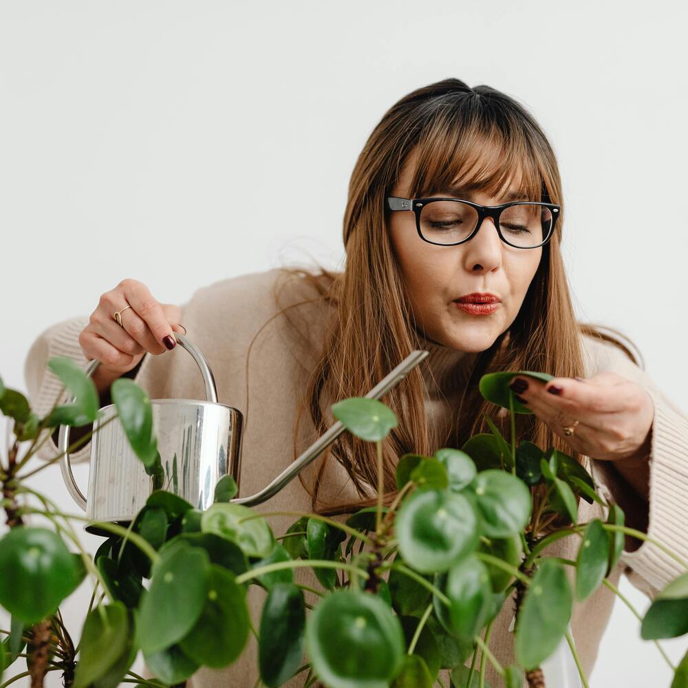 Lady taking care of plant