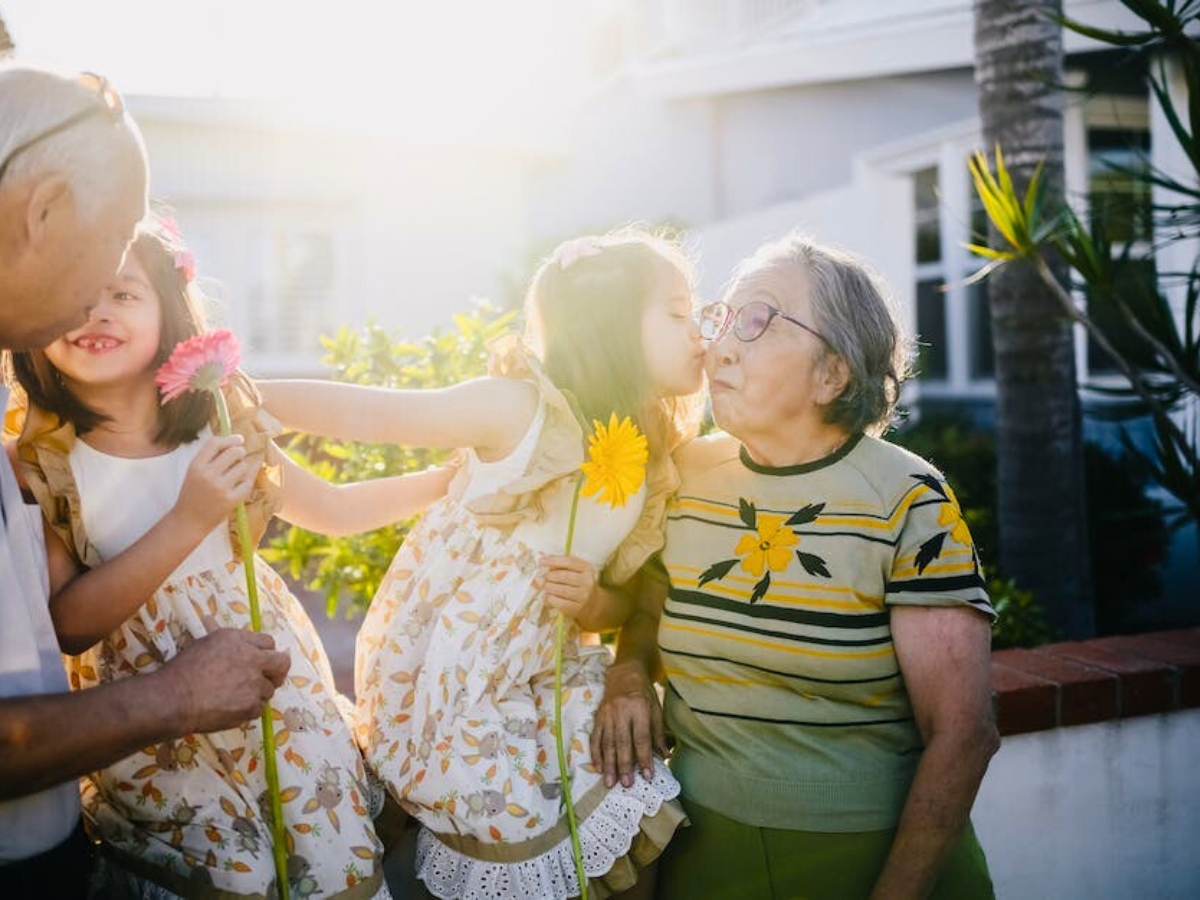 Grandparents and grandchildren with gerberas