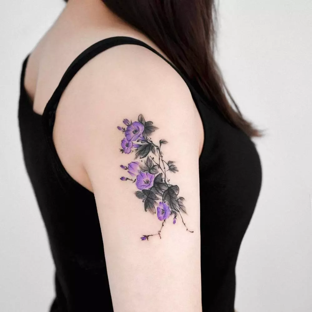 the bright colors of the trumpet shaped flowers in shades of purple make the morning glory a preferable September birth flower tattoo