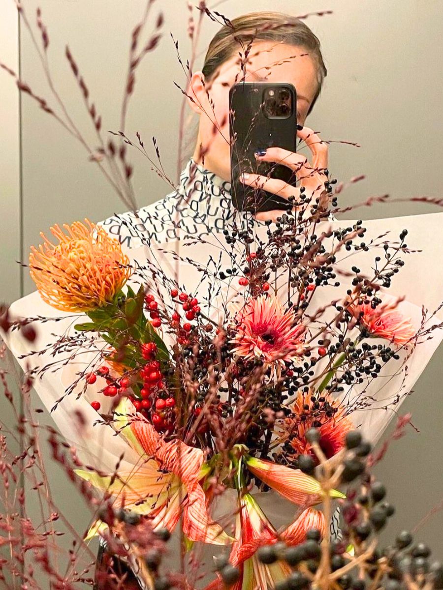 Elizaveta in an elevator with flowers