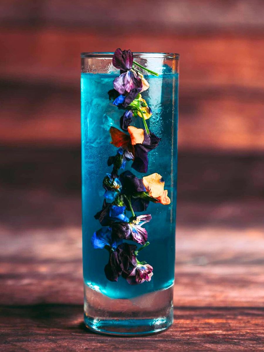 Cocktail with edible pansies and lavender syrup