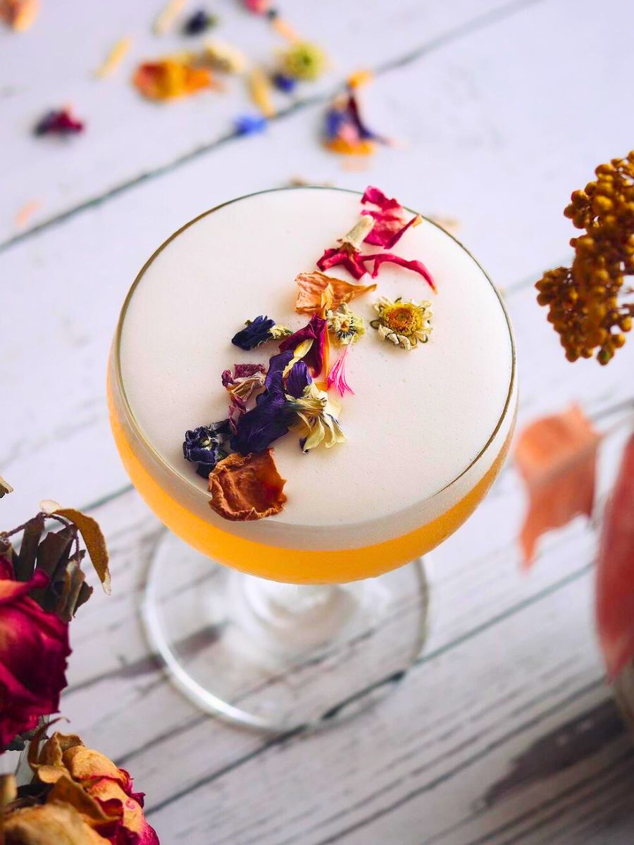 A cocktail creation with edible flowers