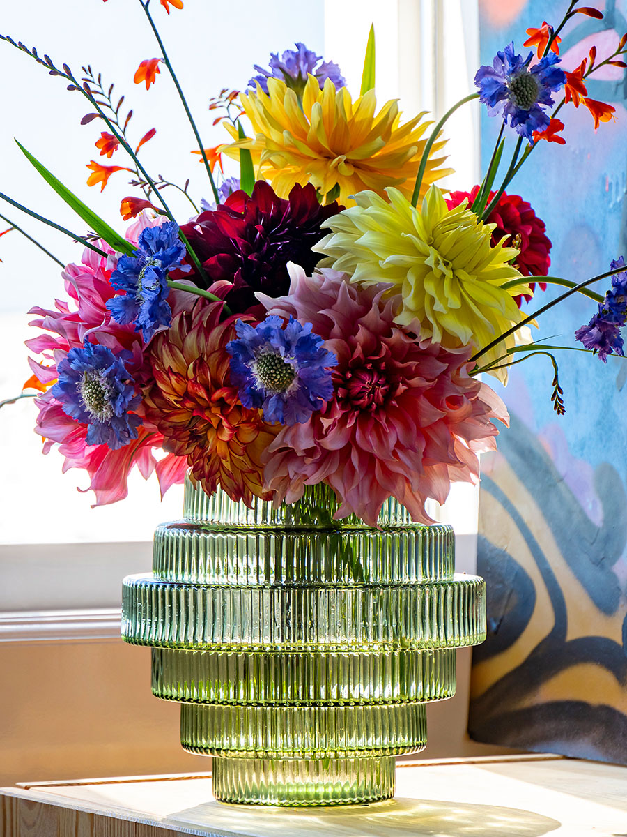 Dahlias in many colors in glass vase