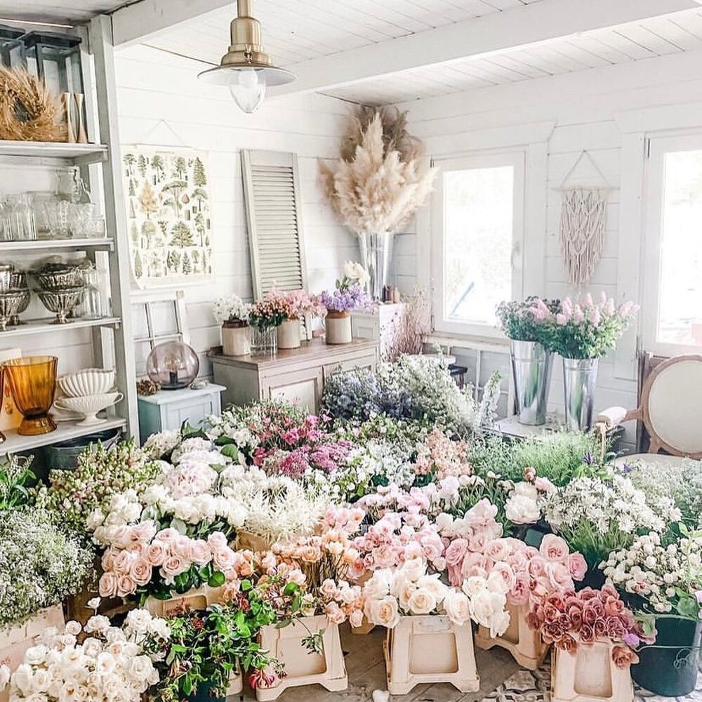 Arranging variety of flowers in flower studio