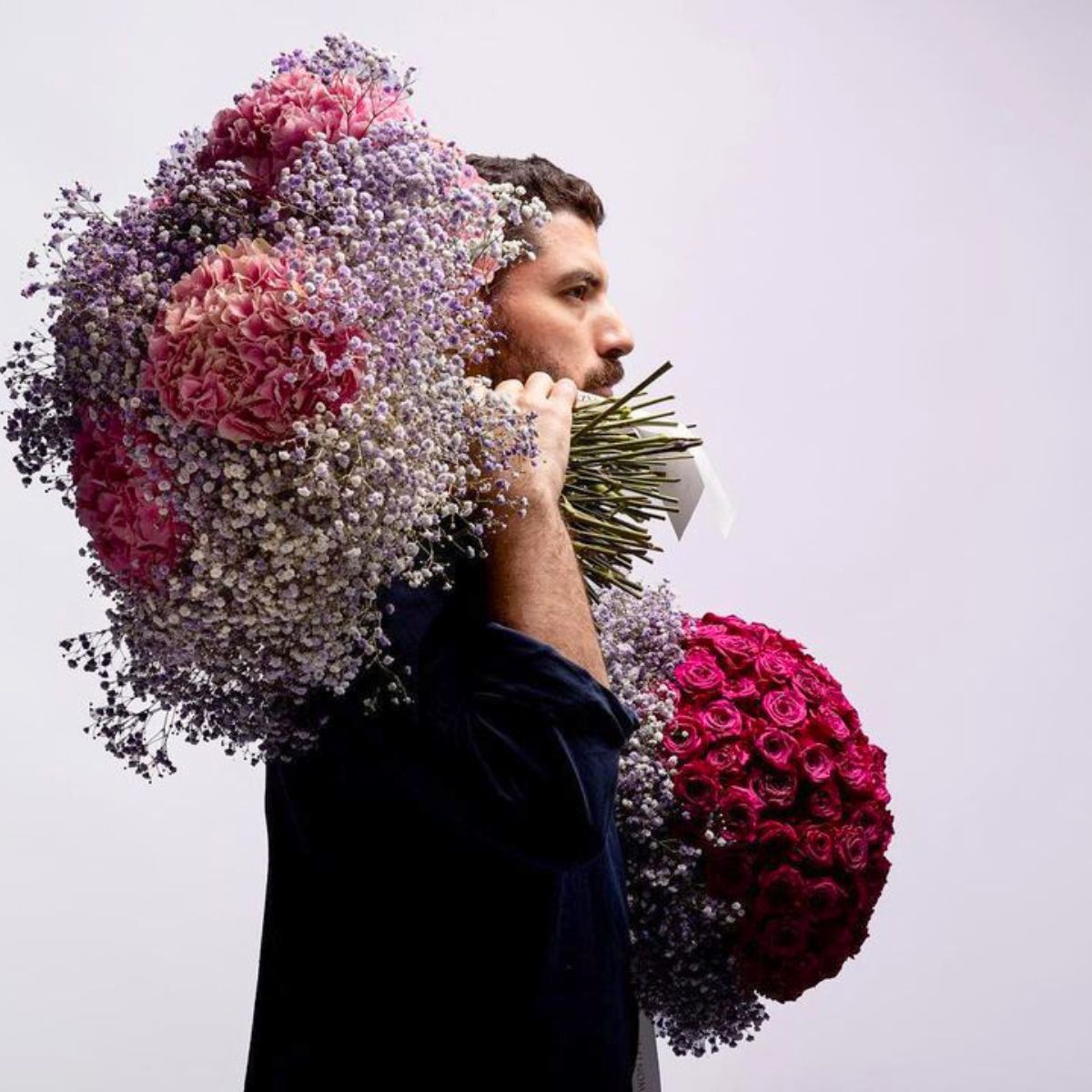 Adbulaziz posing with flower arrangements