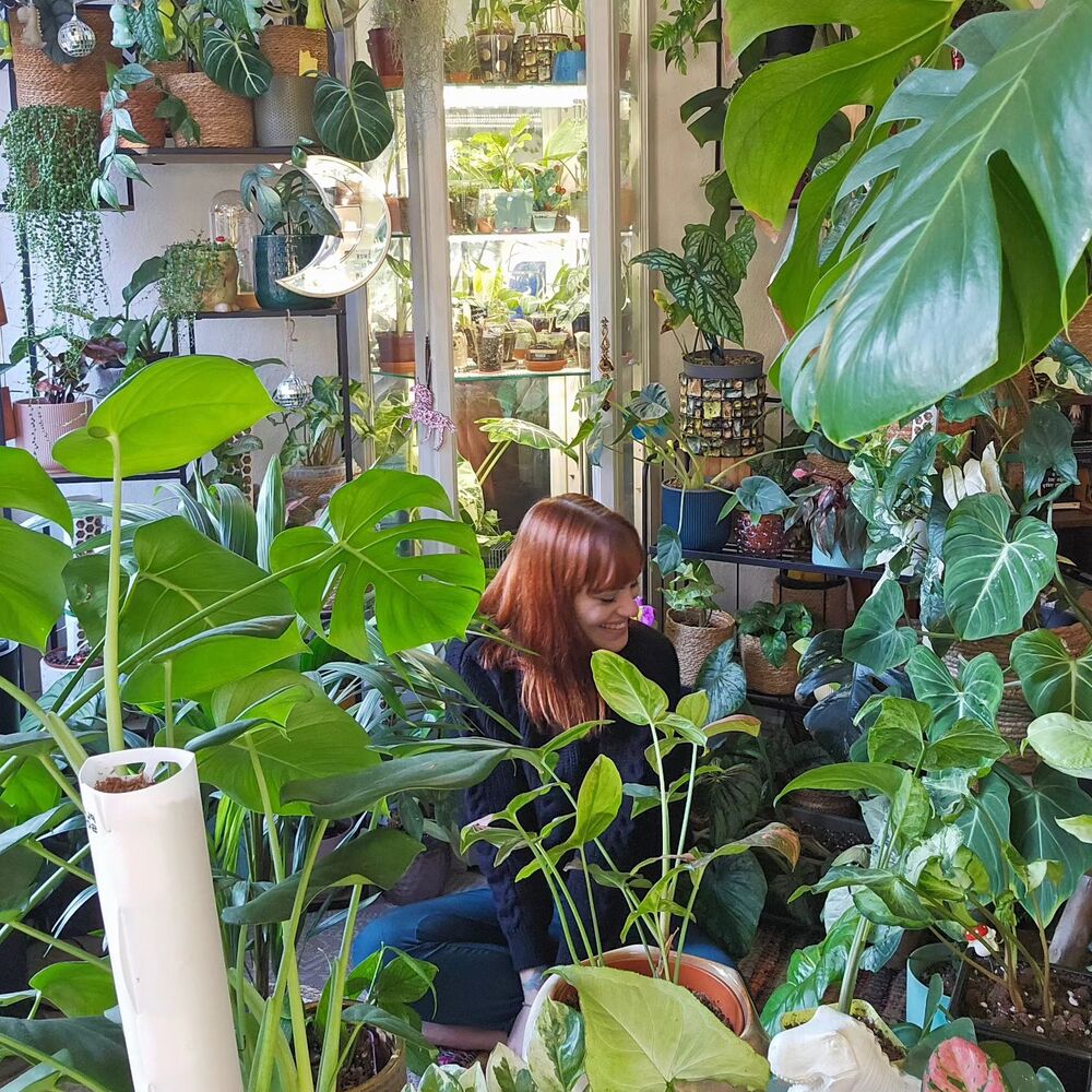 Girl in the mid of houseplants