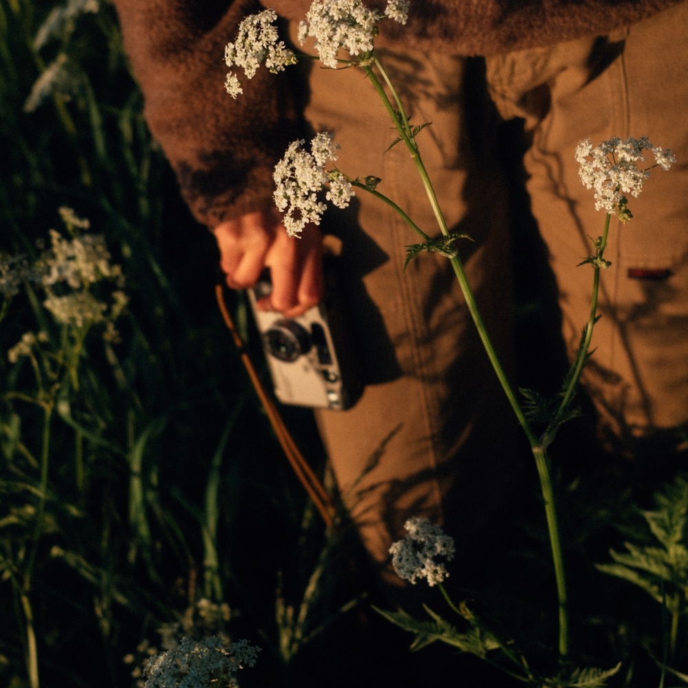 Holding camera for flower photoshoot