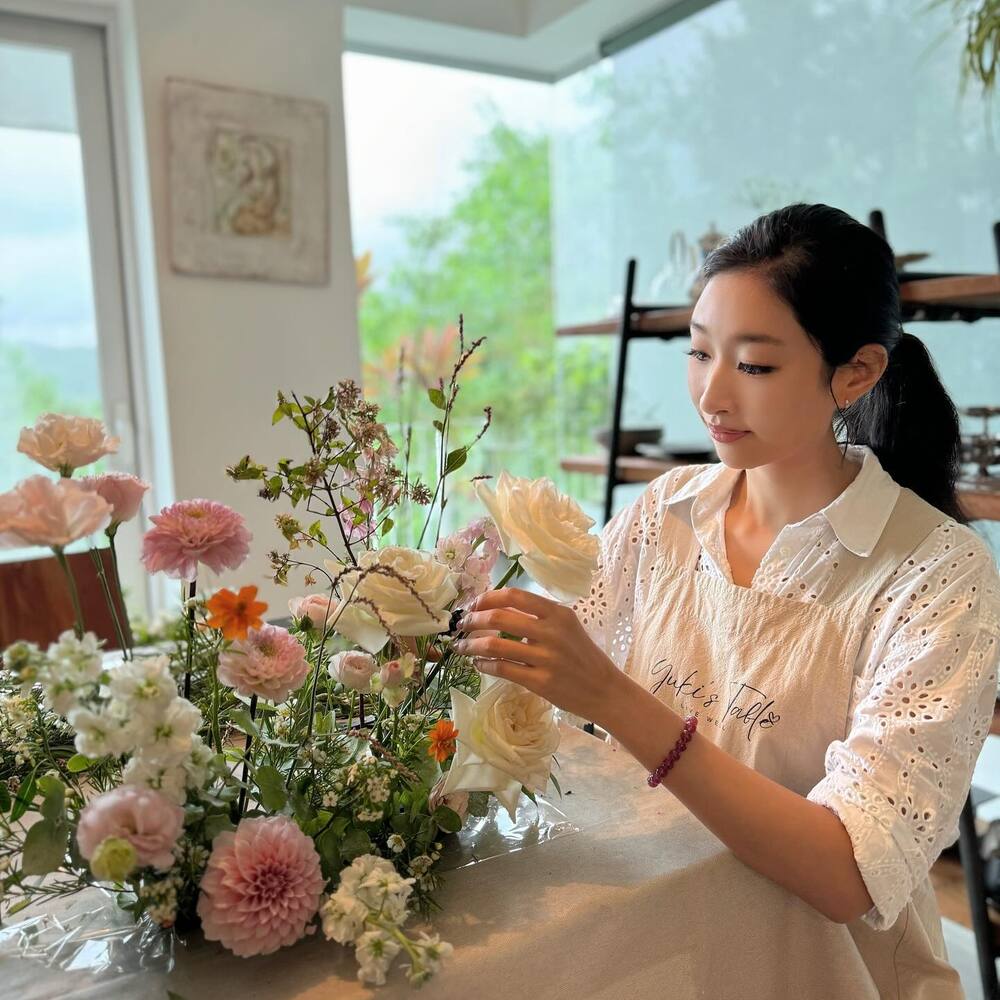 Lady arranging flower in home