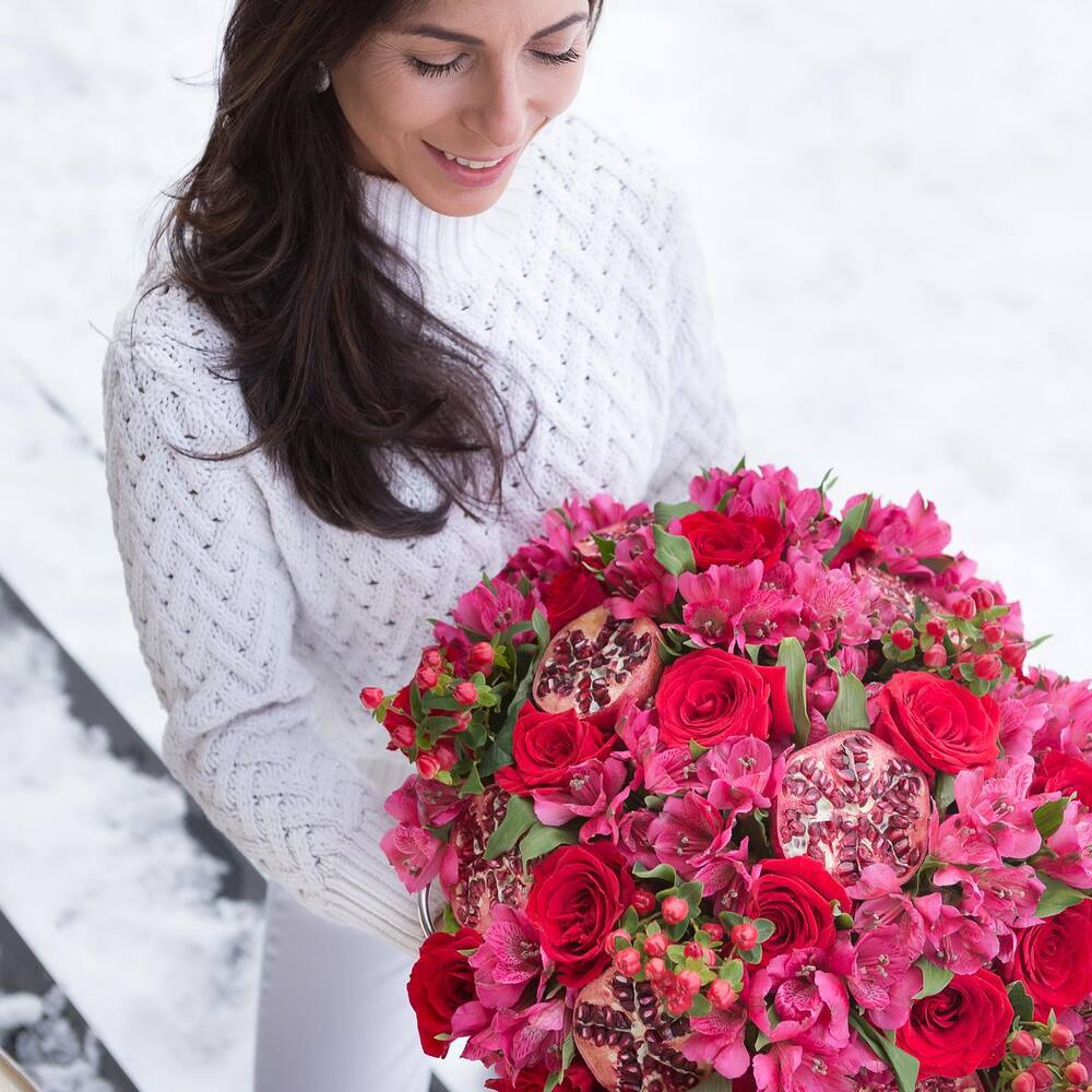 lady holding Red flower bouquet