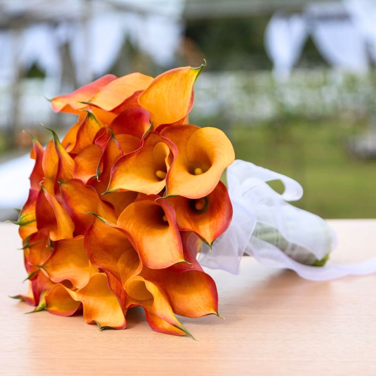 Plain orange wedding bouquet with callas