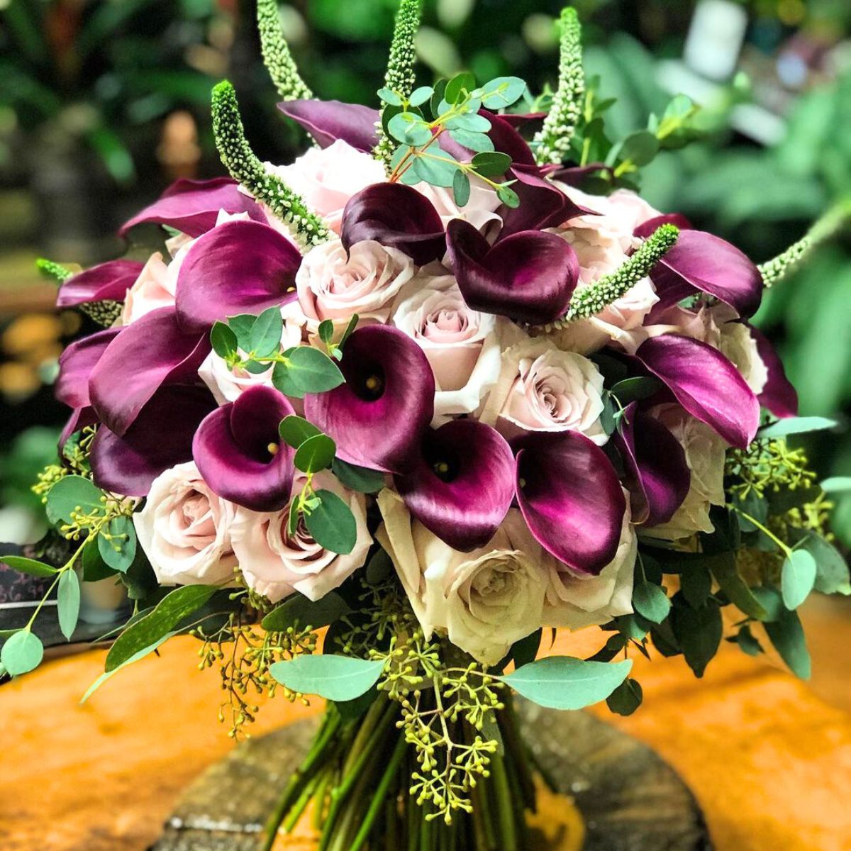 Out of the ordinary wedding bouquet with dark callas