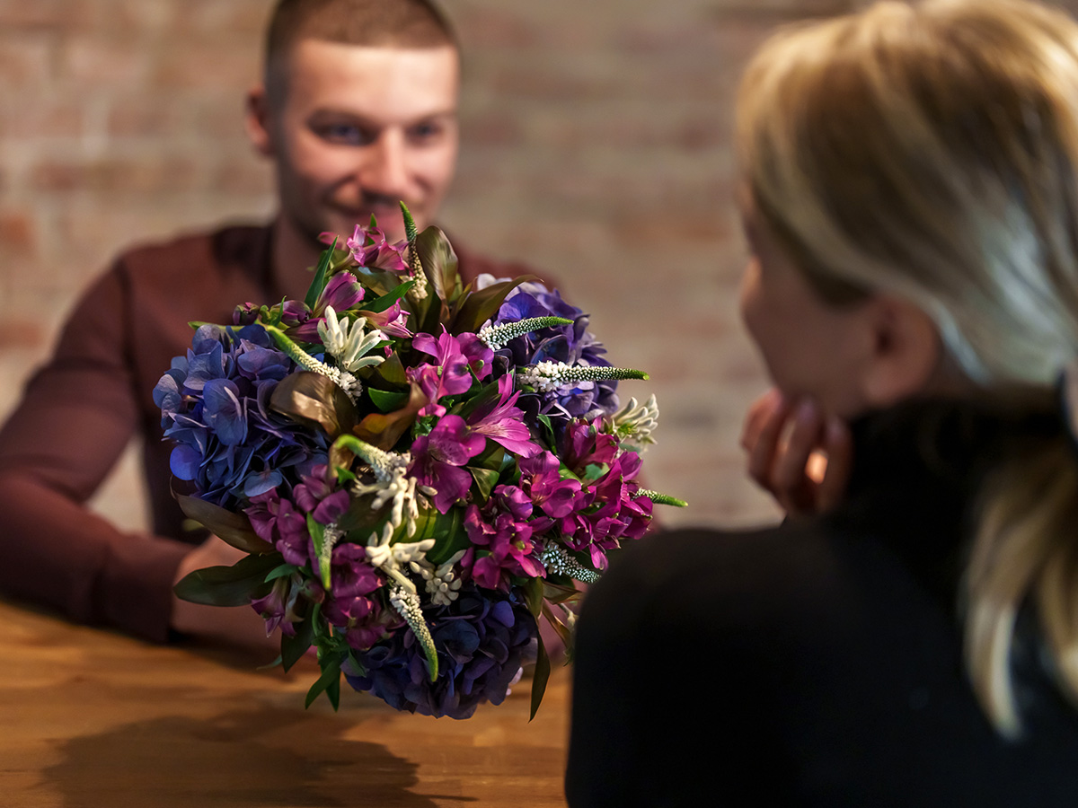 Male model presents bouquet of Alstro Lux