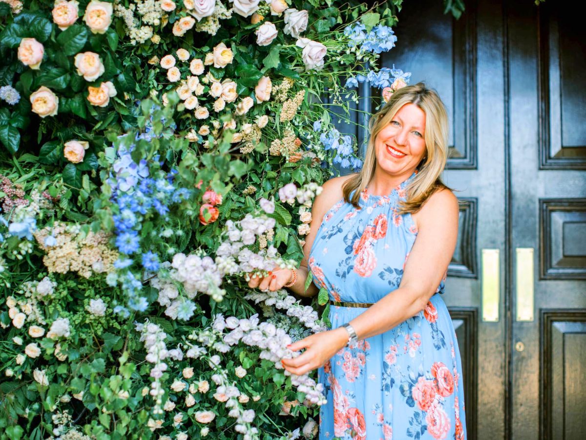 Paula Rooney floral designer among flowers