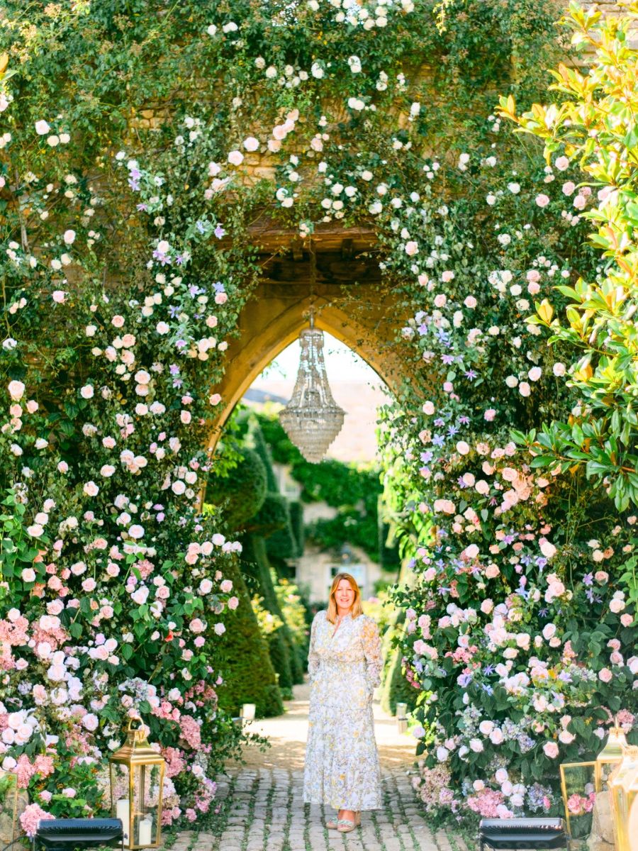 Paula Rooney under a floral bridge decoration