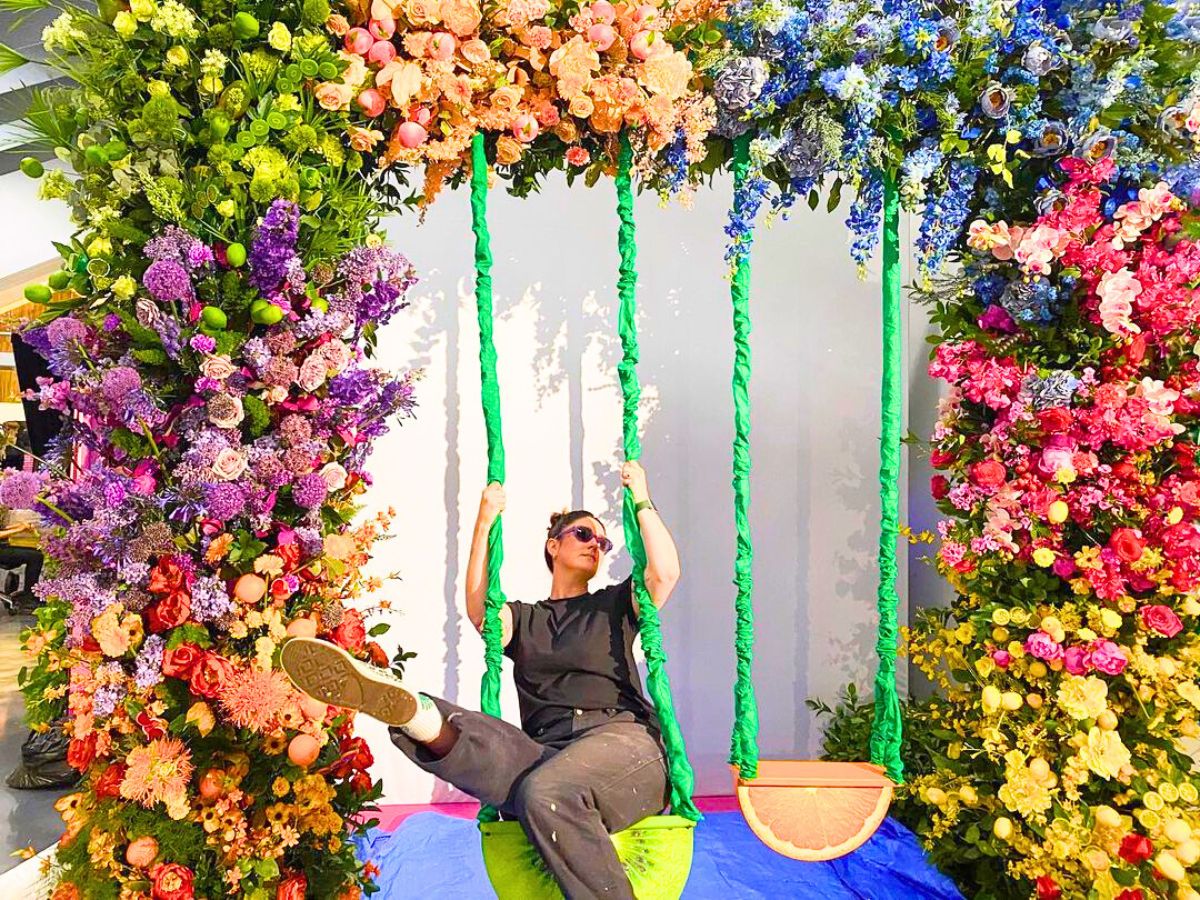 Julie Guinta amongst a huge flower arch