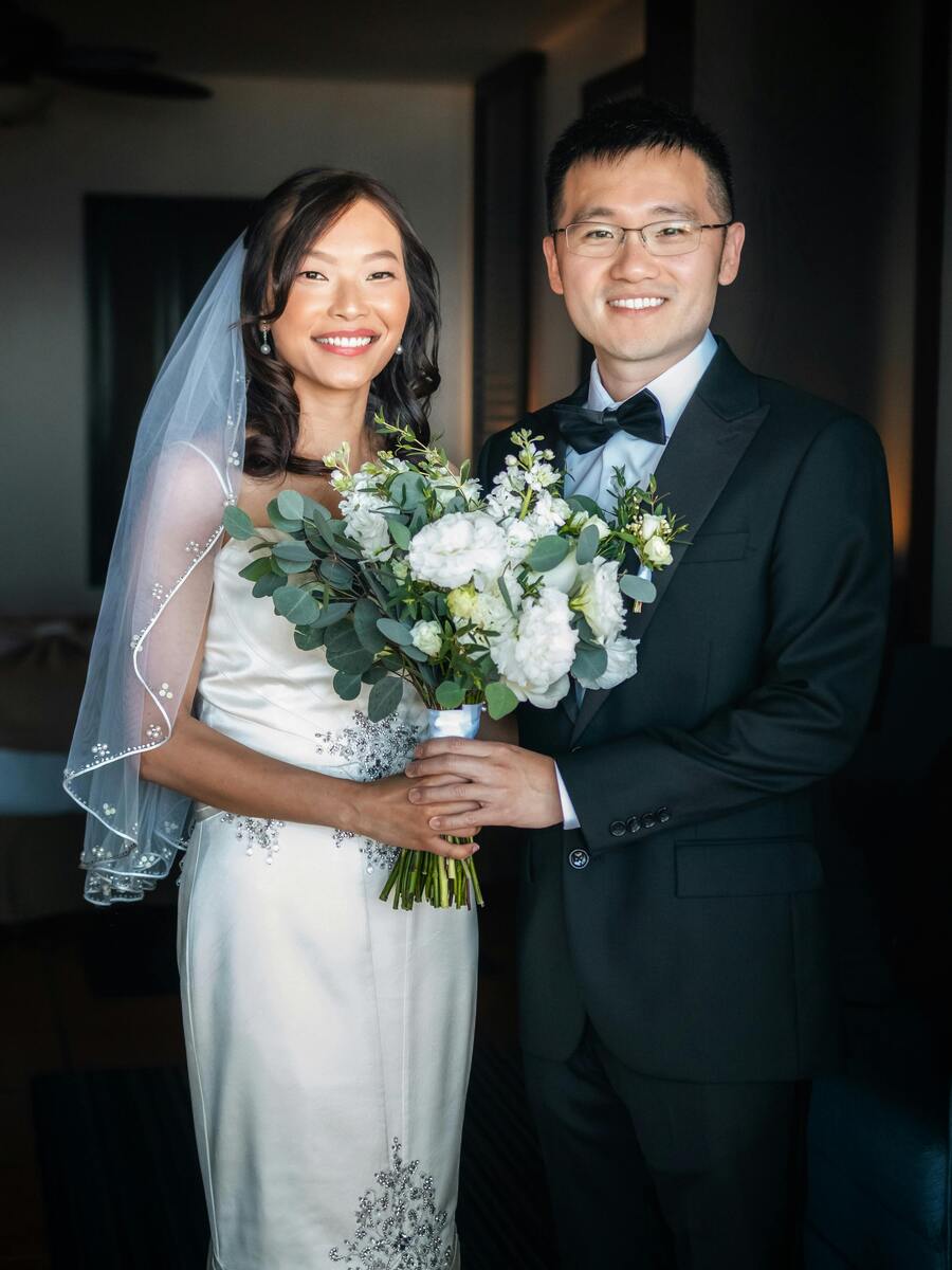 Couple hold flower bouquet at wedding 