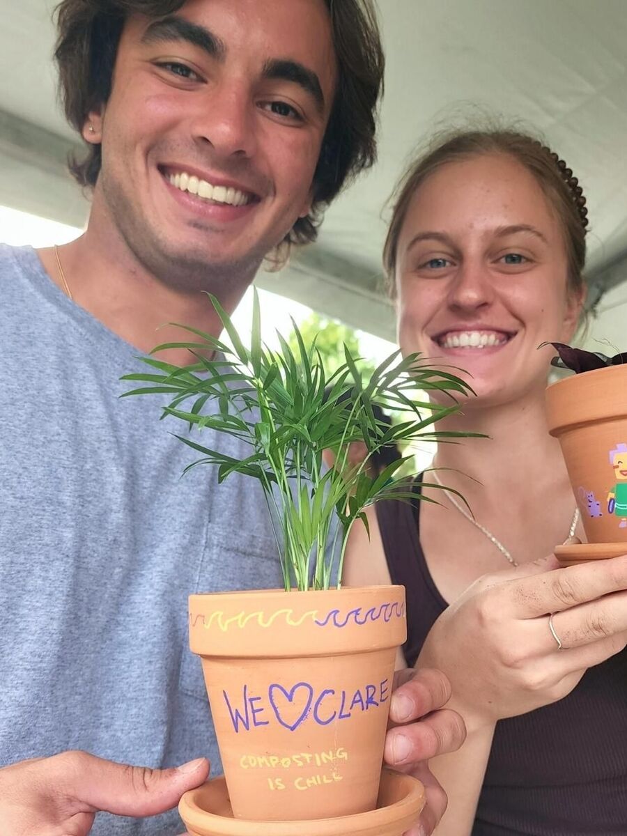 Couple holding small home plant