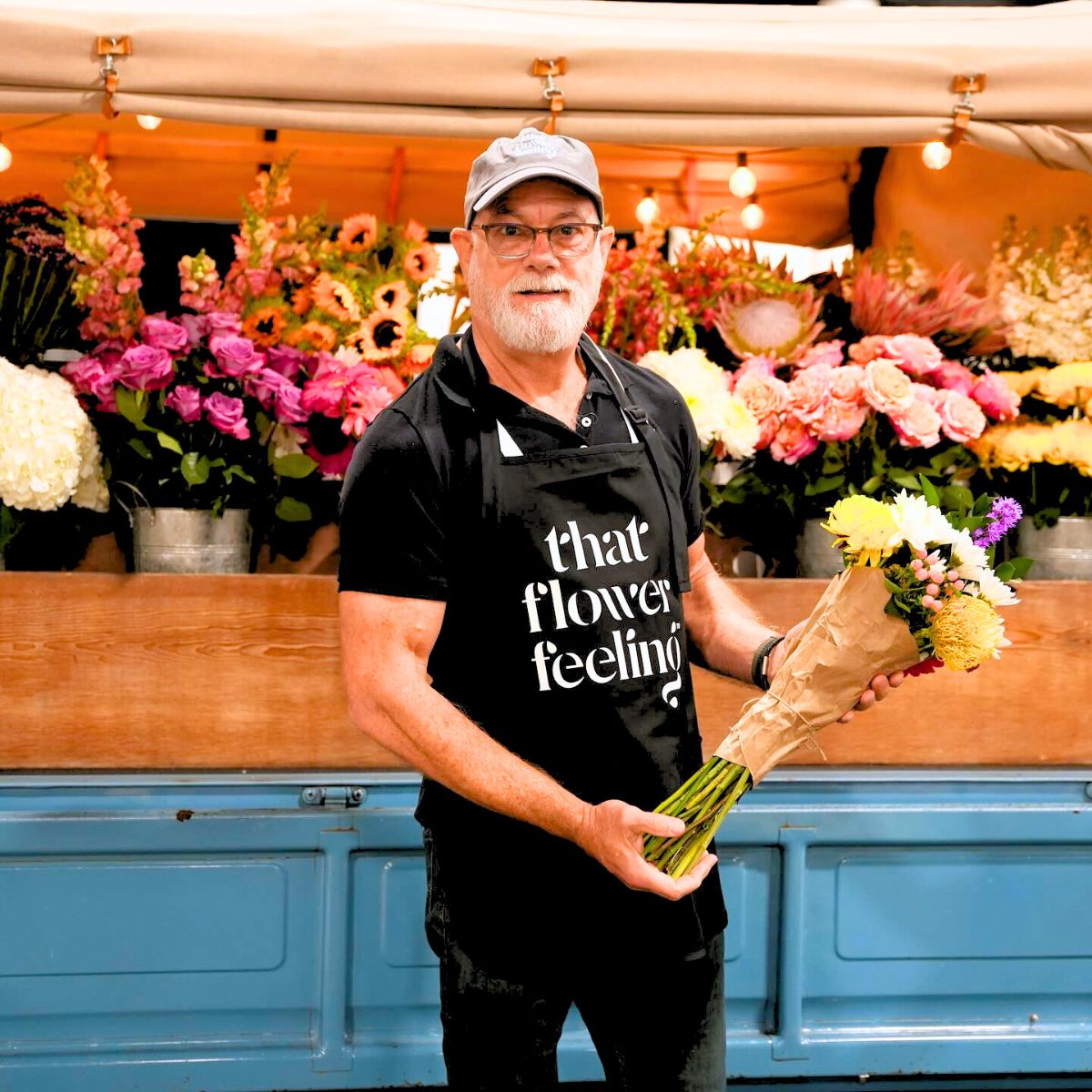 Man with a bouquet of flowers by That Flower Feeling