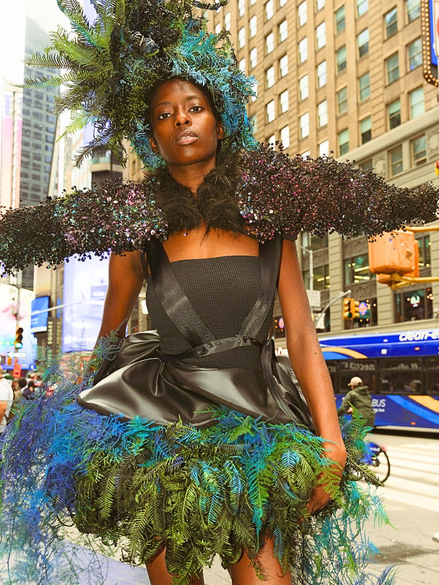 Model with green and blue leafy garment