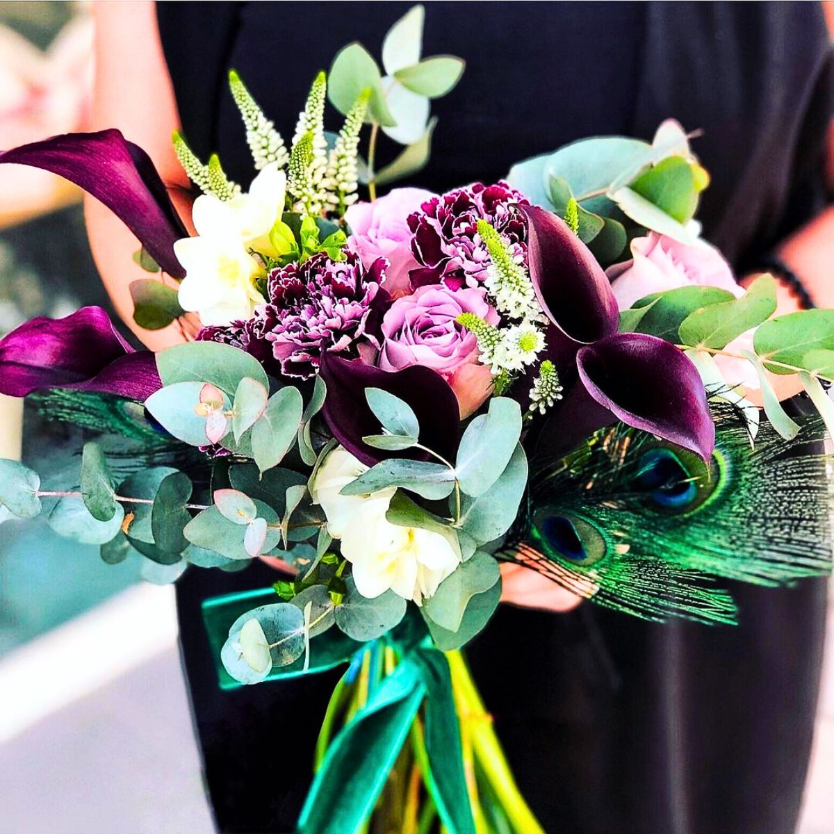 The perfect fall bouquet with greens and deep purple callas