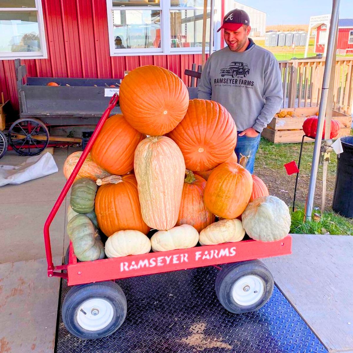 A wagon of different pumpkin sizes