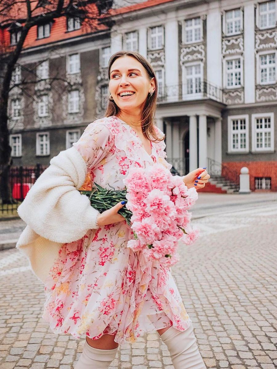 Girl walking with a bouquet of pink carnations