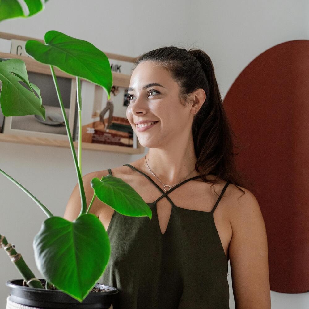 Lady holding indoor plant