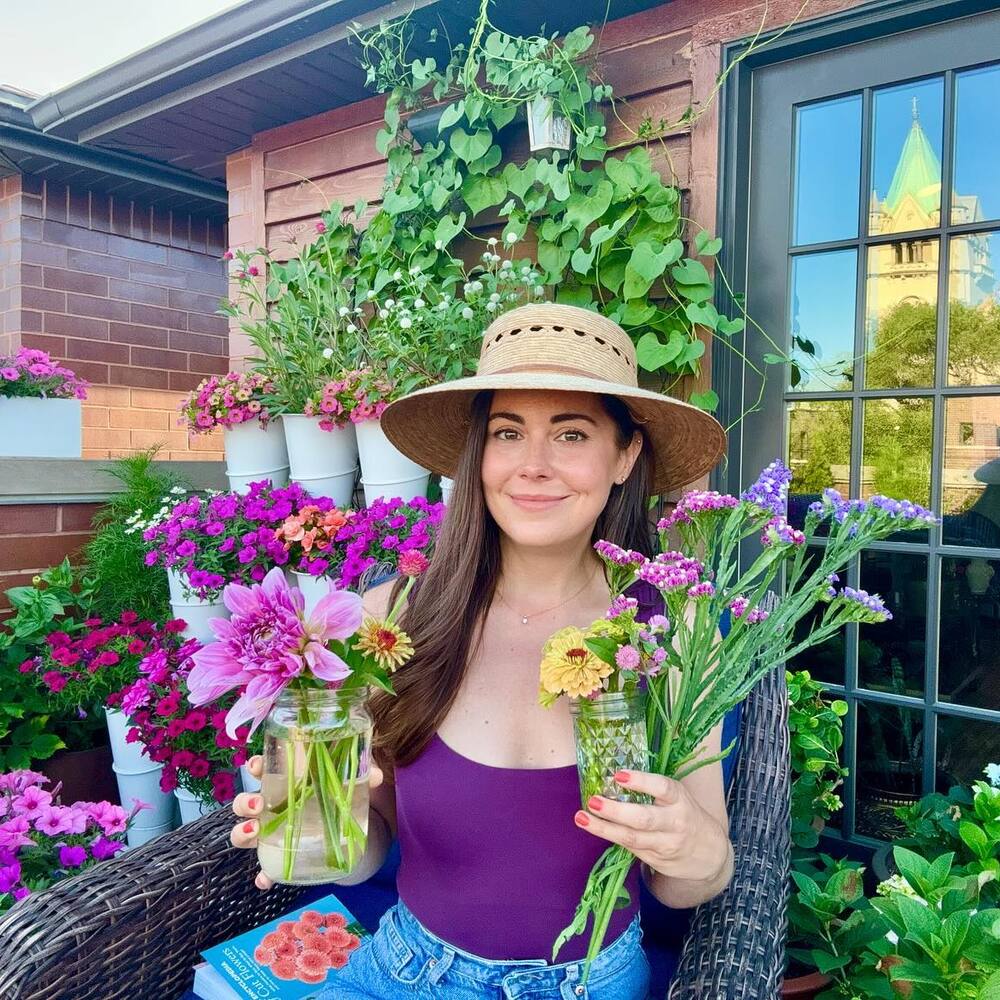 Girl holding colorful flower at garden area