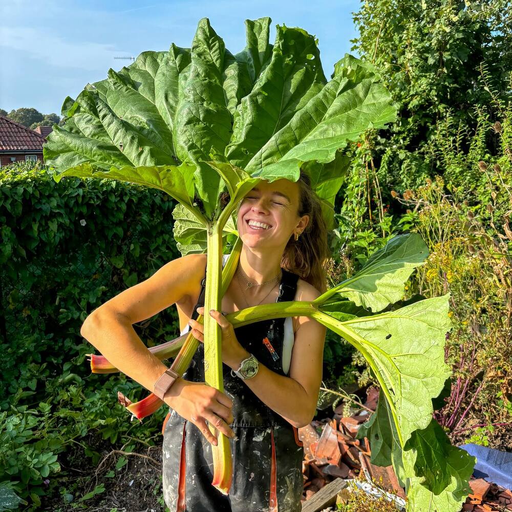 lady holding plant for garden