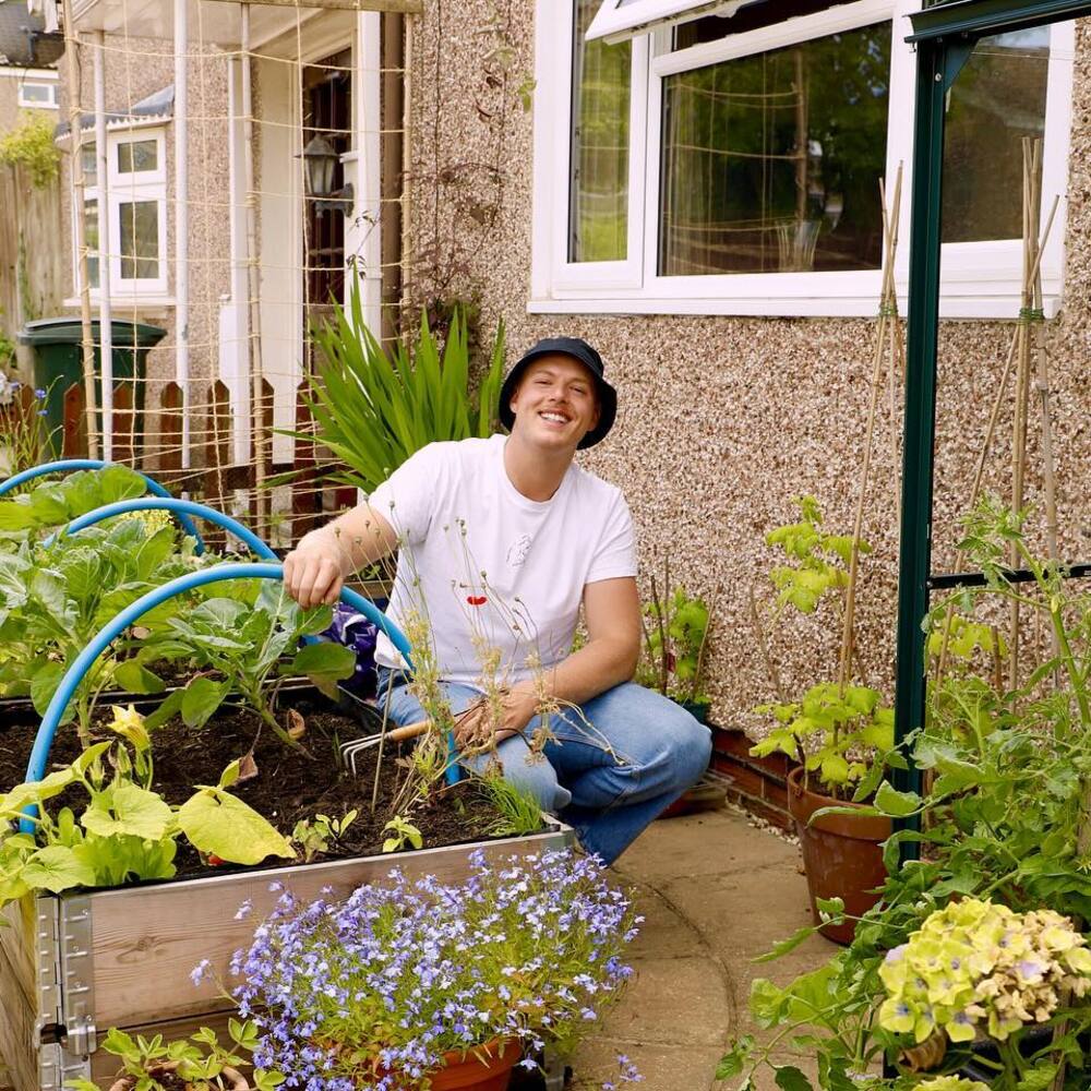 Man seating next to the garden area