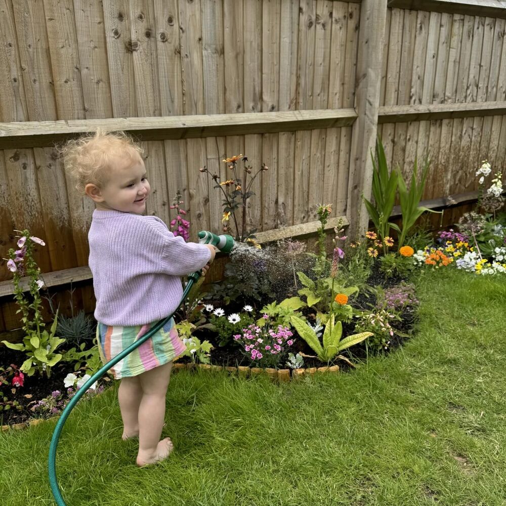 baby watering to garden plant