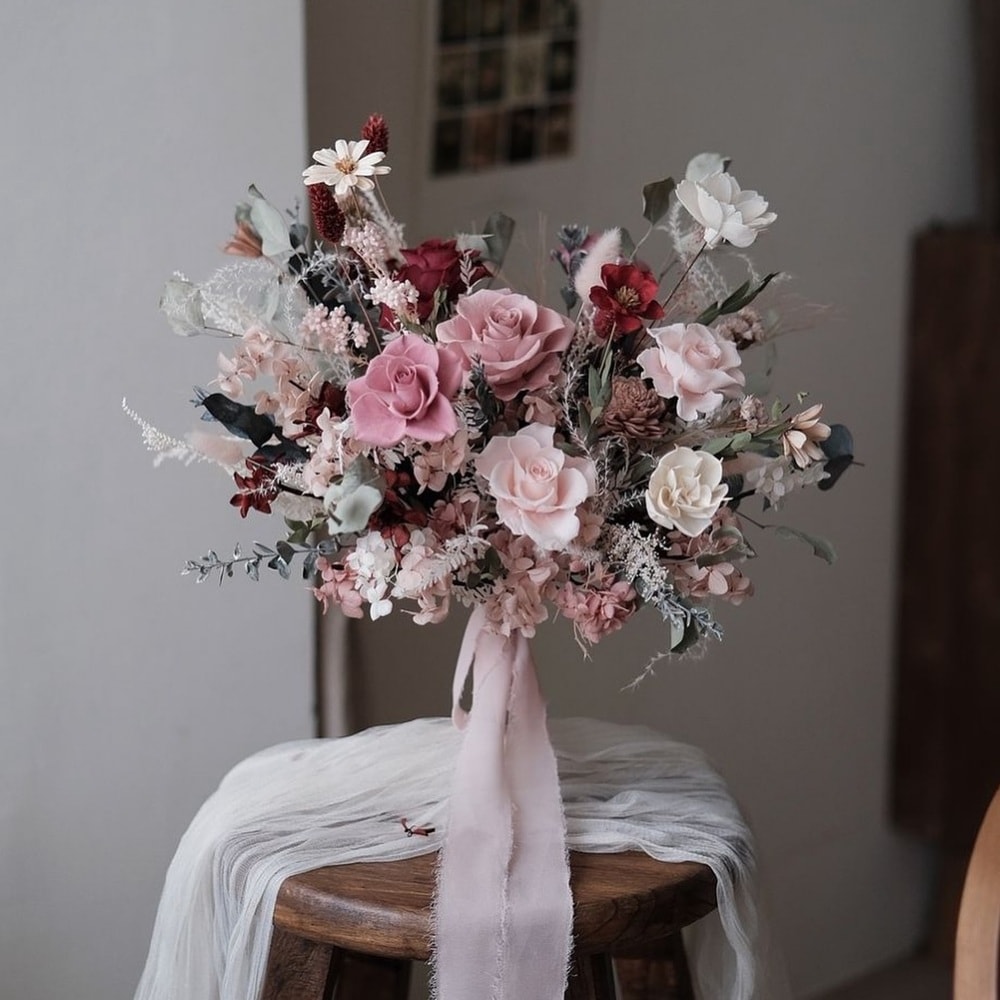 a beautiful vase of colored preserved roses